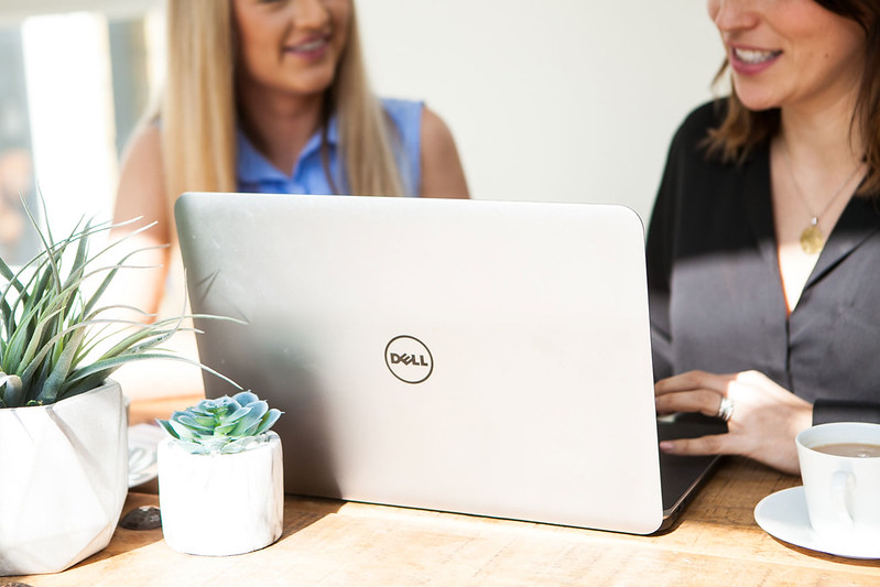 Two people working on a content marketing strategy on a laptop.